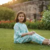 Aqua blue floral girls cotton co-ord set seated profile view, cozy and trendy outfit