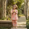 Peach floral girls cotton co-ord set lifestyle candid shot, soft and breathable kids outfit