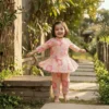 Peach floral girls cotton co-ord set playful pose, fun and flexible kids wear