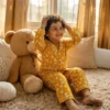 Kids yellow truck print winter night suit candid shot, cozy and playful sleepwear