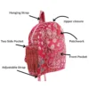 Red floral patchwork kids backpack detail close-up, fabric texture and stitching quality