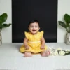 Yellow cotton infant frock profile view, soft and comfortable outfit for babies