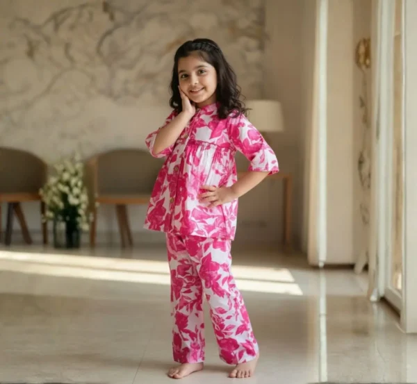 Pink floral girls cotton co-ord set playful pose, fun and flexible outfit for kids