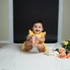 Yellow cotton infant frock candid shot, soft and comfortable baby clothing