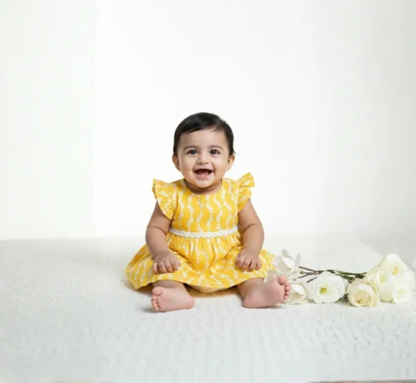 Yellow cotton infant frock front view, lightweight and stylish baby wear