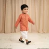 Orange Dhoti Kurta for boys walking view showing printed kurta and white dhoti