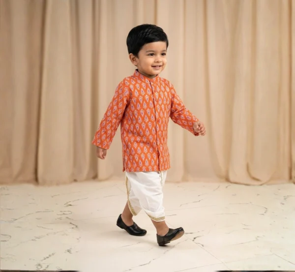 Orange Dhoti Kurta for boys walking view showing printed kurta and white dhoti